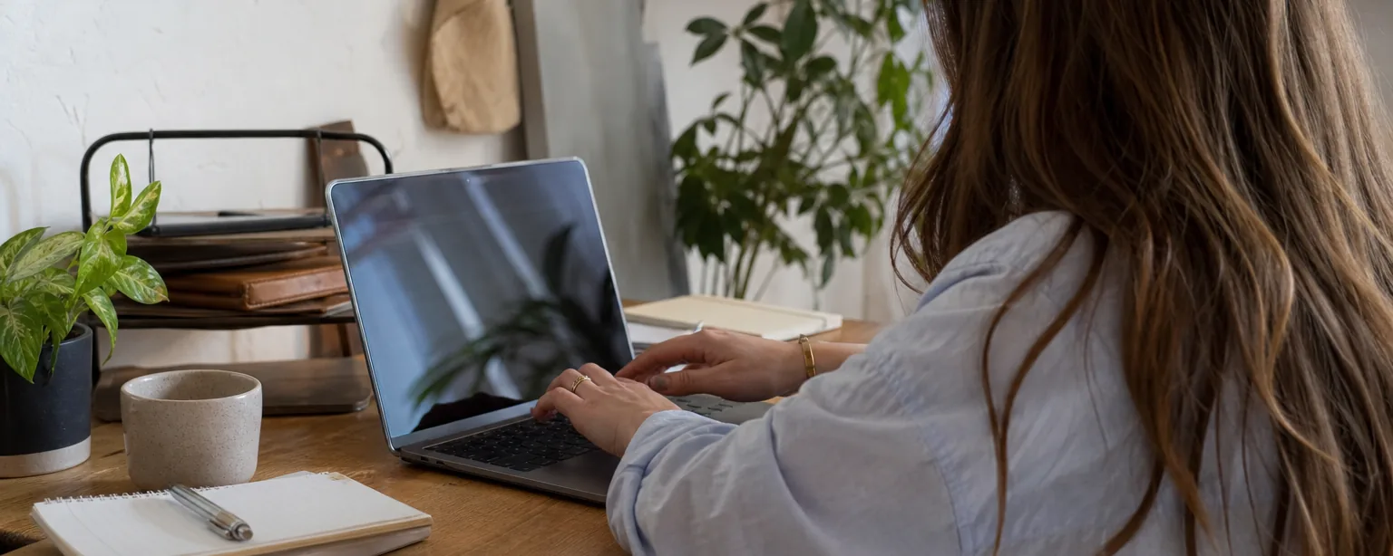 Office manager setting up an email forwarding rule on a laptop